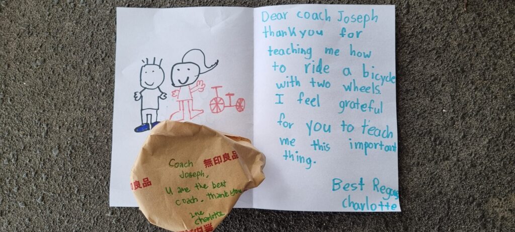 A handwritten thank-you note from a young learner to Coach Joseph for teaching her to ride a bicycle with two wheels